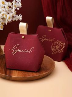 two pieces of red paper with the word special written on them, sitting on a wooden plate