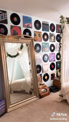 a room with records on the wall and a mirror