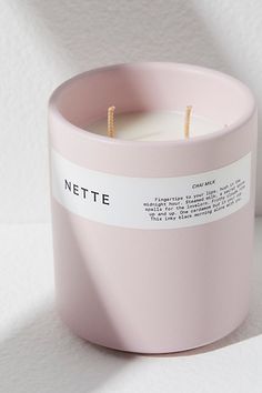 a pink candle sitting on top of a white table