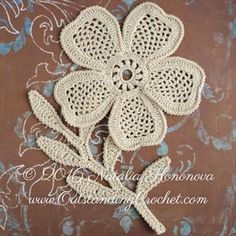 a crocheted flower on a brown background