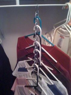 several shirts hanging on a rack in a closet