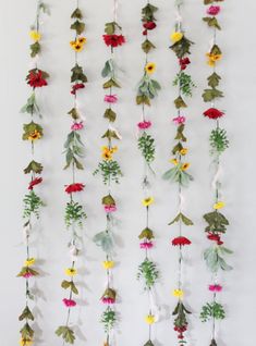 an arrangement of flowers hanging on a wall