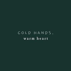 the words cold hands, warm heart against a dark green background