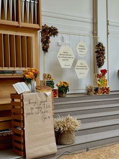 a bunch of flowers that are sitting on the steps in front of a church organ