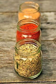 three jars filled with different types of spices