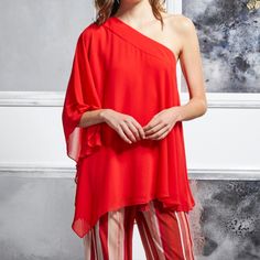 New Badgley Mischka Georgette One Shoulder Top. Size Medium Top, Bright Siam Red In Color, Fully Lined. This Loose Fitting, Breathable Summer Top Will Catch Their Eye As It Playfully Reveals A Single Shoulder. Feminine And Fun, This Top Is Perfect For Lunch Dates And Sunny Days. This Lightweight Blouse Drapes Elegantly From Your Shoulder To Your Upper Thigh, Featuring An Asymmetrical Design. Sheer Layers And Flowing Sleeves Perfect This Look. Perfect For At Home Entertaining Or A Special Night O Elegant Red Top For Evening, Elegant Red Tops For Evening, Elegant Red Evening Top, Elegant Red Party Tops, Chic Red Holiday Tops, Elegant Red Top For Wedding, Red One-shoulder Party Top, Elegant Holiday Cocktail Tops, Flowing Sleeves