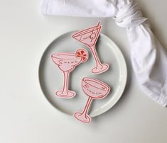 a white plate topped with two coasters next to a napkin on top of a table