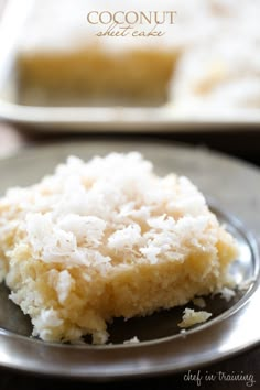 a piece of coconut sheet cake on a plate