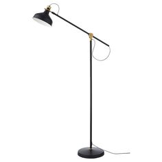 a black and gold floor lamp with an adjustable arm, on a white background the light is dimming