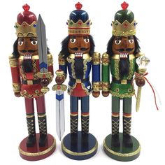 three wooden nutcrackers are standing next to each other