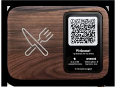 a wooden cutting board with a qr code on the front and a fork in the back