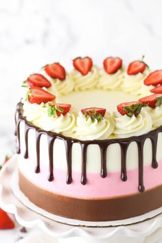 a cake with white frosting and strawberries on top