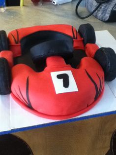 a cake shaped like a race car on top of a table