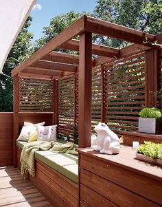 a wooden bed sitting on top of a wooden floor next to a lush green forest