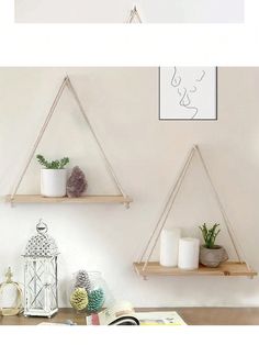 two hanging shelves with plants and candles on them