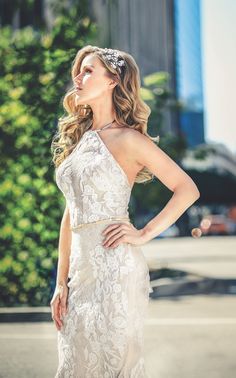 a woman in a white dress posing for the camera