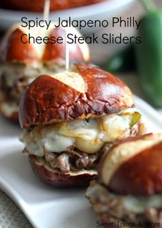 three mini sandwiches with cheese and meat on them