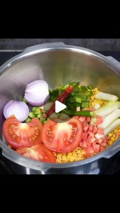 a pot filled with vegetables and onions on top of a stove