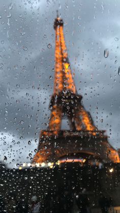 the eiffel tower seen through a rainy window