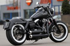 a black motorcycle parked in front of a building