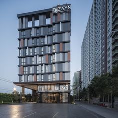 an empty parking lot in front of a tall building