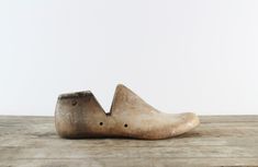 a wooden shoe sitting on top of a wooden table