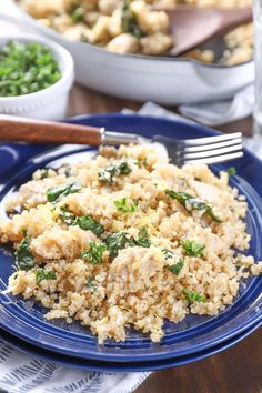 a blue plate topped with rice and spinach