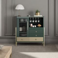 a living room with a green cabinet next to a white couch and coffee cup holder