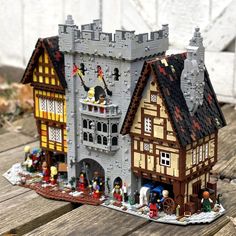 a lego house is shown on a wooden table