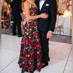 a man and woman standing next to each other on a dance floor in formal wear