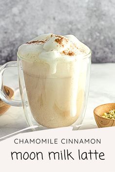 there is a cup of coffee with whipped cream on top and the words chamole cinnamon moon milk latte above it