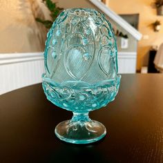 a glass bowl sitting on top of a wooden table