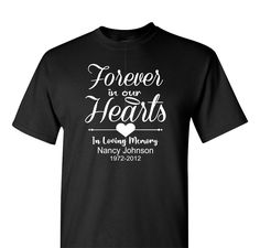 This unisex Memorial T-shirt is crafted with premium cotton for a lasting, comfortable fit. Featuring a heartfelt design with "Forever in our Hearts" on the back, it's a warm and touching symbol to honor a lost loved one. This "Forever in our Hearts" Memorial T-shirt with a name and a date is a beautiful way to keep that person gone to soon close to your heart at all times. Say it proudly with this made to order garment. Personalization comes at no extra charge. Shown in black and Navy Blue SHIR Forever In Our Hearts Shirts, In Loving Memory Tshirt Design, In Loving Memory Shirt, In Loving Memory T Shirts Ideas, Memorial T Shirts Ideas Design, R I P Shirts Ideas, Black Heart-shaped Graphic Tee, Rip Tshirt Ideas, Memorial Tshirt Ideas With Picture