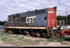 an old rusty train sitting on the tracks