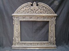 an ornate silver frame on a black background