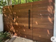 a wooden gate in front of a house