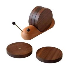 a wooden toy snail with two pieces of wood on it's back and one piece missing