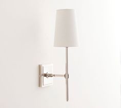 a white lamp is mounted on the wall