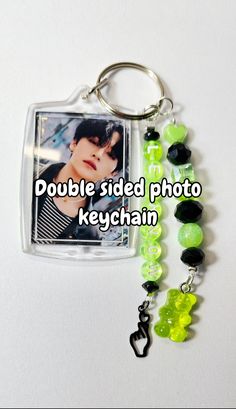 a keychain with a photo on it and some beads hanging from the side