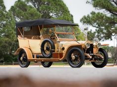 an antique car is parked on the street