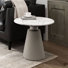 a living room with a black chair and white marble table in front of the couch