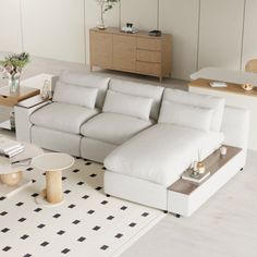 a living room filled with furniture and a large white couch in front of a window