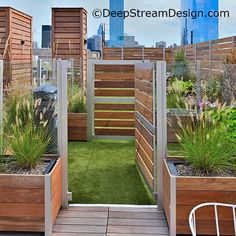 a rooftop garden with wooden planters and grass