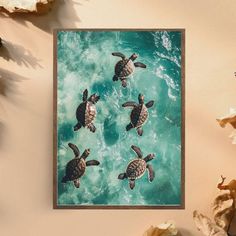 three sea turtles swimming in the ocean on a blue and green watercolored background