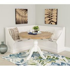 a white bench sitting in the middle of a living room next to a table and chairs