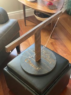 a clock sitting on top of a black box in a living room next to a chair