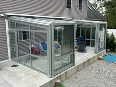 an enclosed patio with two lawn chairs on it