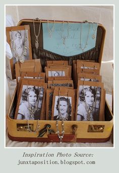 an open suitcase filled with photos and jewelry