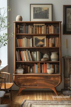 a bookshelf filled with lots of books in a living room