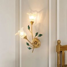 a wall light with two flowers on it